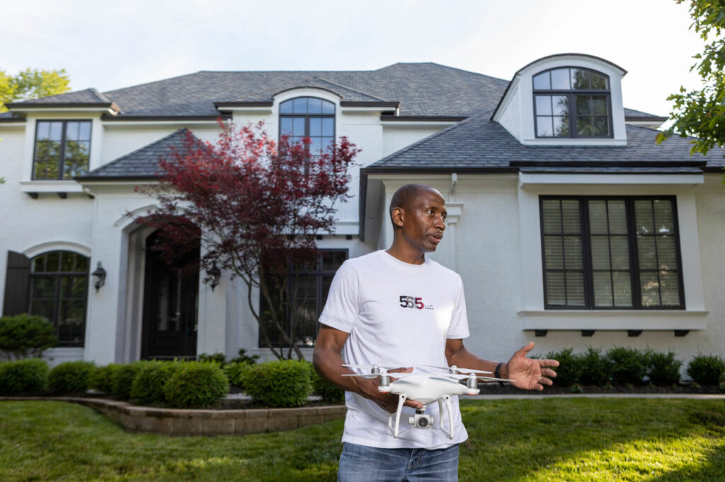 Small business owner Reggie Hines holds a drone