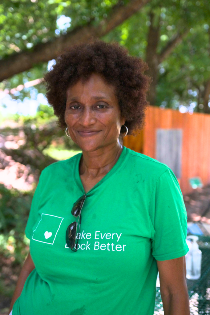 Carol Ainsworth, project nominator, smiling at the camera and wearing a green t-shirt